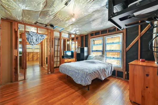 a room with wooden floor and furniture