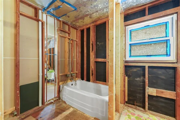 a bedroom with a bed closet and wooden floor