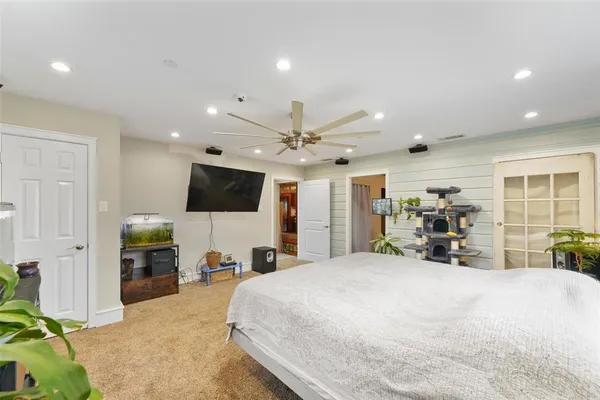 a large bedroom with a bed and a large window