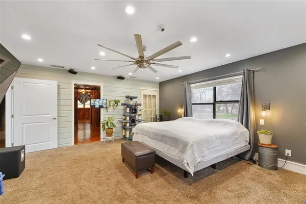 a bed room with a bed and a large window