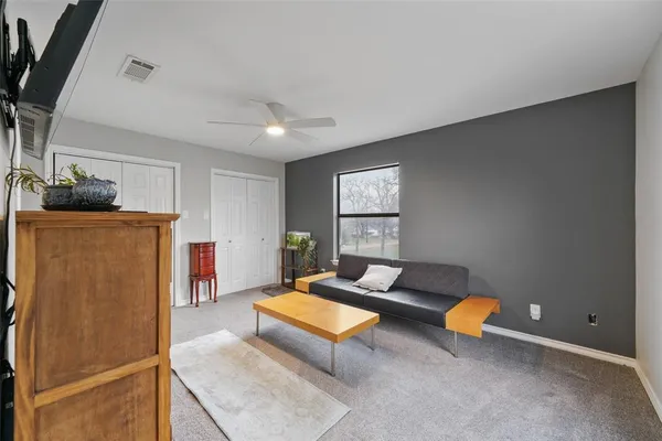 a living room with furniture pool table and a window