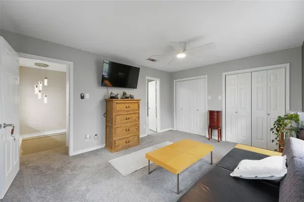 a bedroom with furniture and flat screen tv