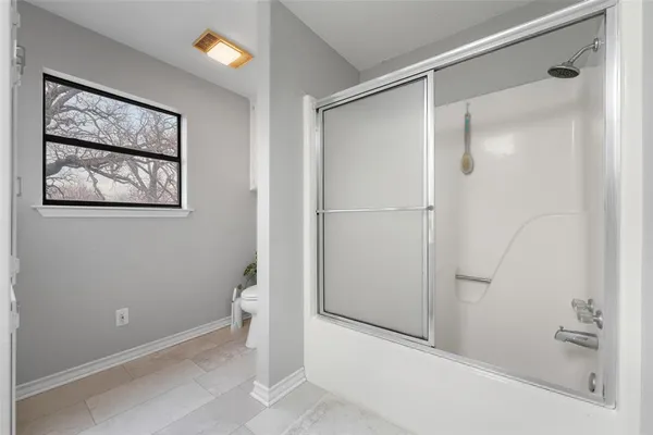 a bathroom with a shower and a toilet