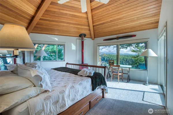 a bed sitting in a bedroom next to a window