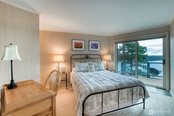 a bedroom with a bed and a lamp next to a window