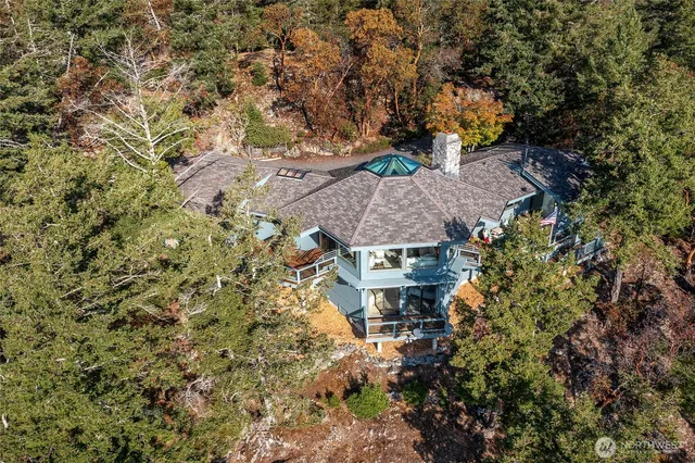 an aerial view of a house with a yard