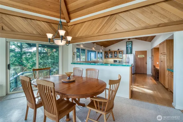 a dining room with furniture a chandelier and window