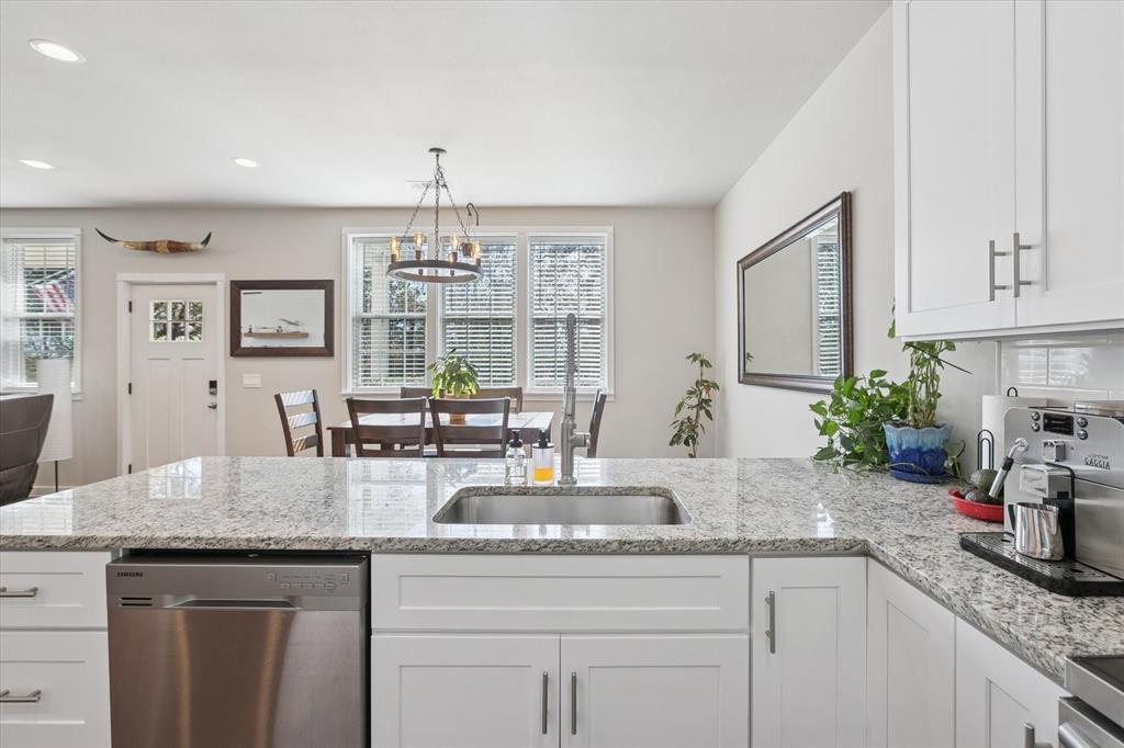 7232 Courtney Drive Azle, TX 76020 - Photo 12 of 39 a kitchen with granite countertop a sink stainless steel appliances and white cabinets
