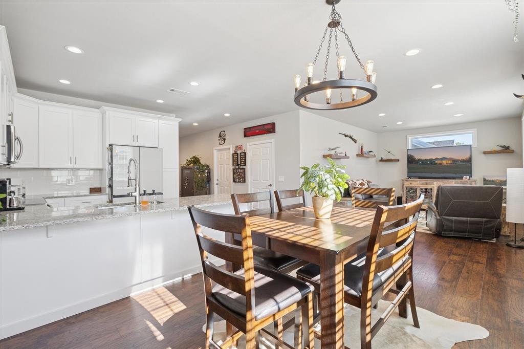 7232 Courtney Drive Azle, TX 76020 - Photo 17 of 39 a view of a dining room with furniture and wooden floor