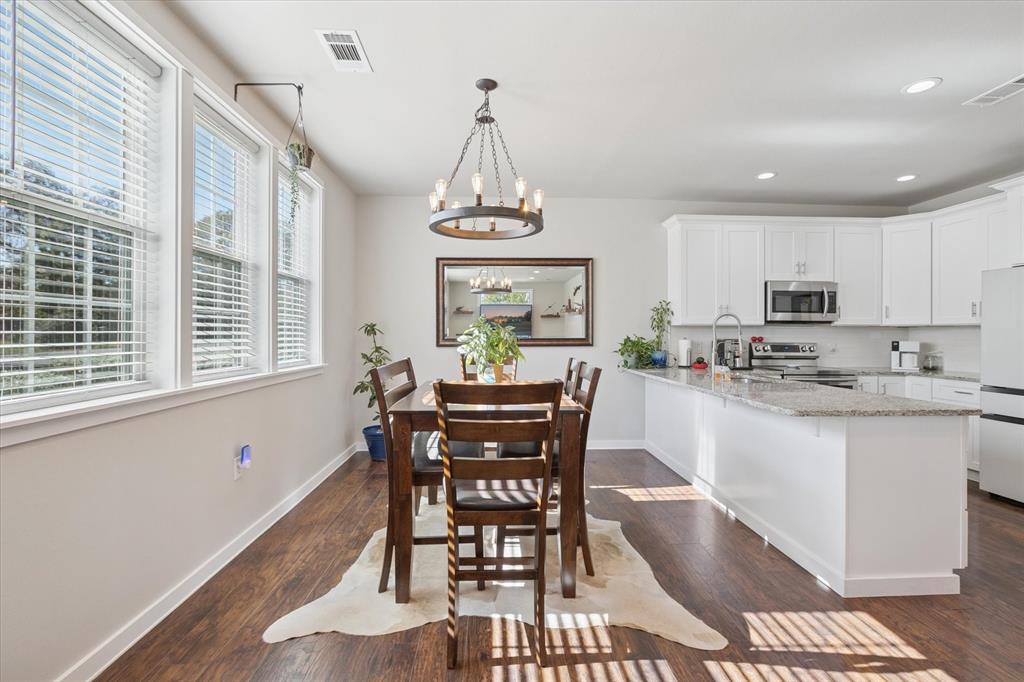 7232 Courtney Drive Azle, TX 76020 - Photo 19 of 39 a view of a dining room with furniture window and wooden floor
