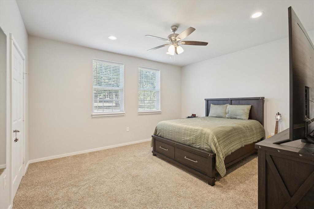 7232 Courtney Drive Azle, TX 76020 - Photo 22 of 39 a spacious bedroom with a bed and a chandelier