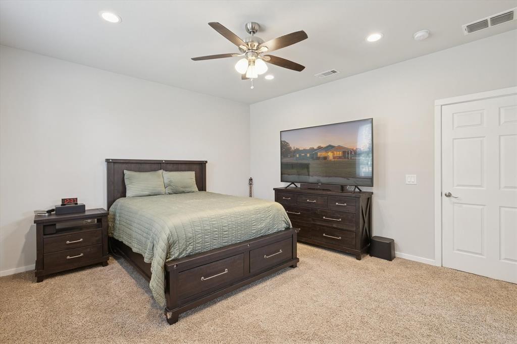 7232 Courtney Drive Azle, TX 76020 - Photo 23 of 39 a bedroom with a bed and a tv