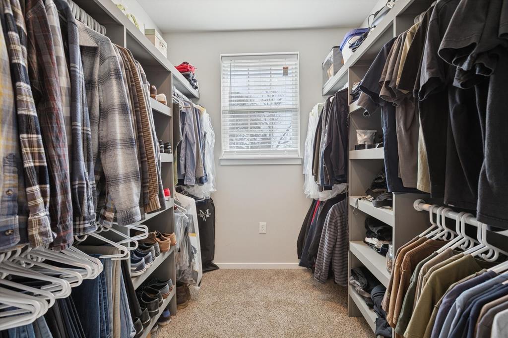7232 Courtney Drive Azle, TX 76020 - Photo 25 of 39 a view of walk in closet with clothes and shoes