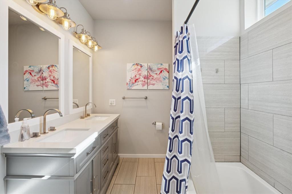 7232 Courtney Drive Azle, TX 76020 - Photo 26 of 39 a bathroom with a sink a mirror and a shower