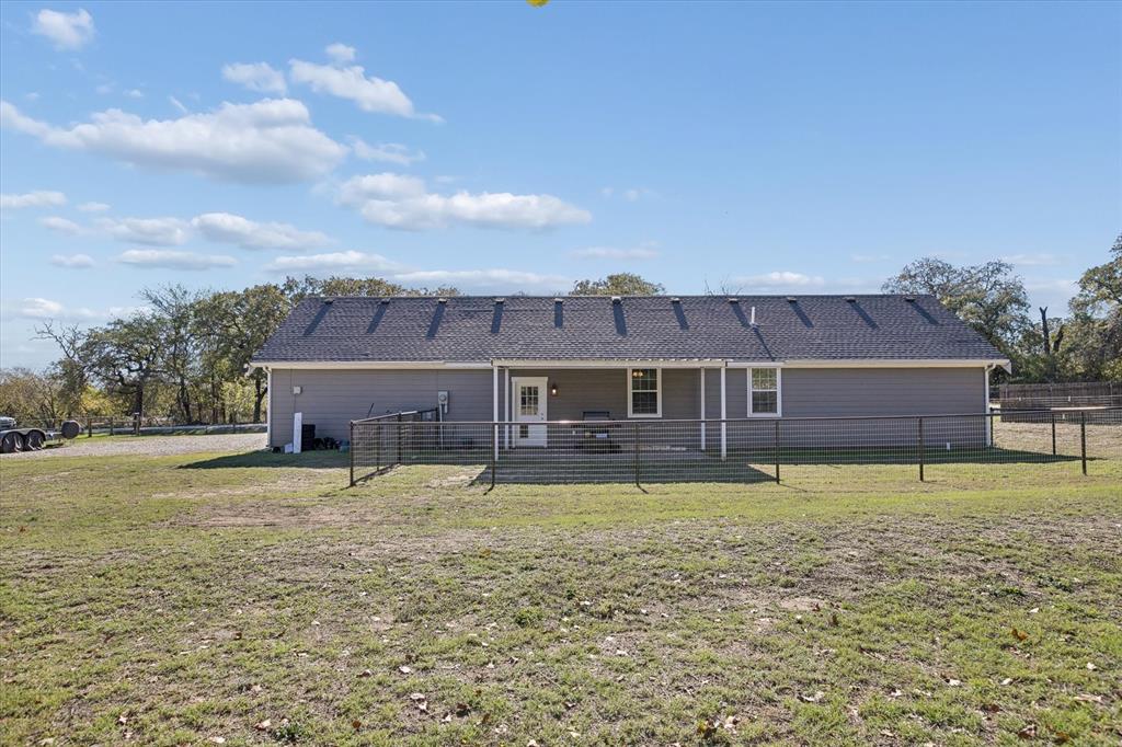 7232 Courtney Drive Azle, TX 76020 - Photo 34 of 39 a house that has a big yard with plants and large trees