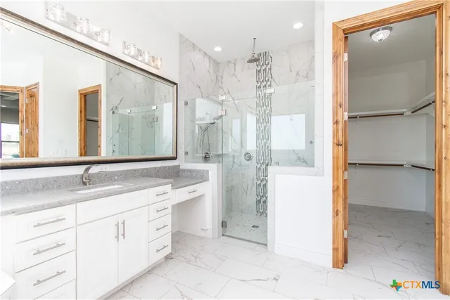 a bathroom with a granite countertop sink mirror and double