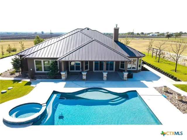 a swimming pool with outdoor seating yard and balcony