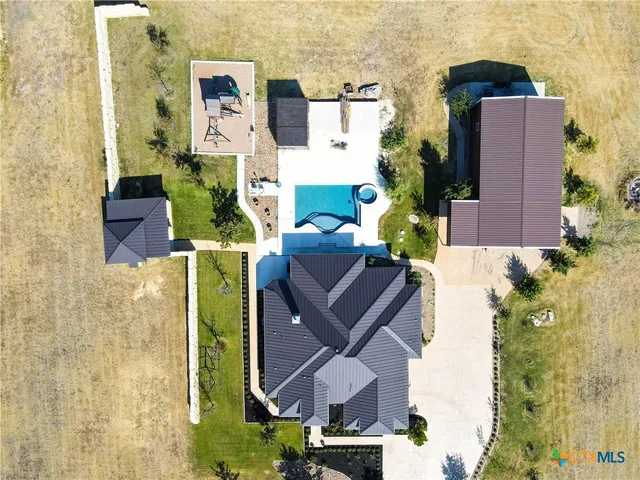aerial view of a house with a yard