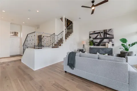 a living room with furniture and a potted plant
