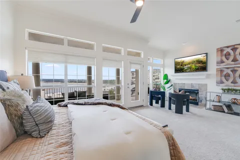 a living room with furniture large window and flat screen tv