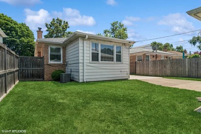 a view of a house with a yard and a garden