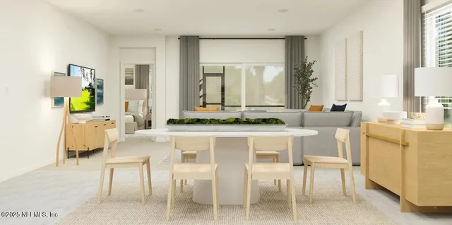 a living room with stainless steel appliances furniture a dining table and a window