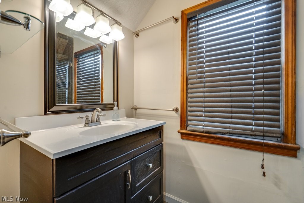 30000 Elgin Road Wickliffe, OH 44092 - Photo 19 of 30 Bathroom vanity featuring a white countertop with an integrated sink and a brushed nickel faucet