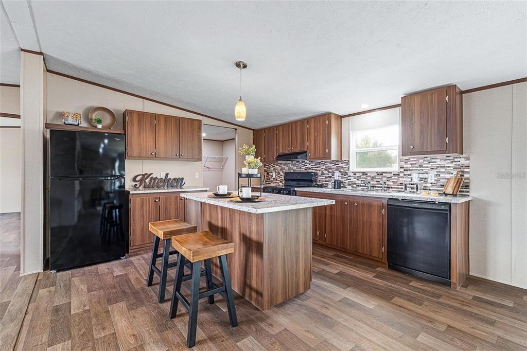 8150 Cherokee Road Bartow, FL 33830 - Photo 12 of 35 a kitchen with a sink refrigerator and cabinets