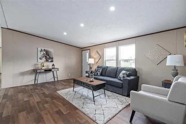 a living room with furniture and wooden floor