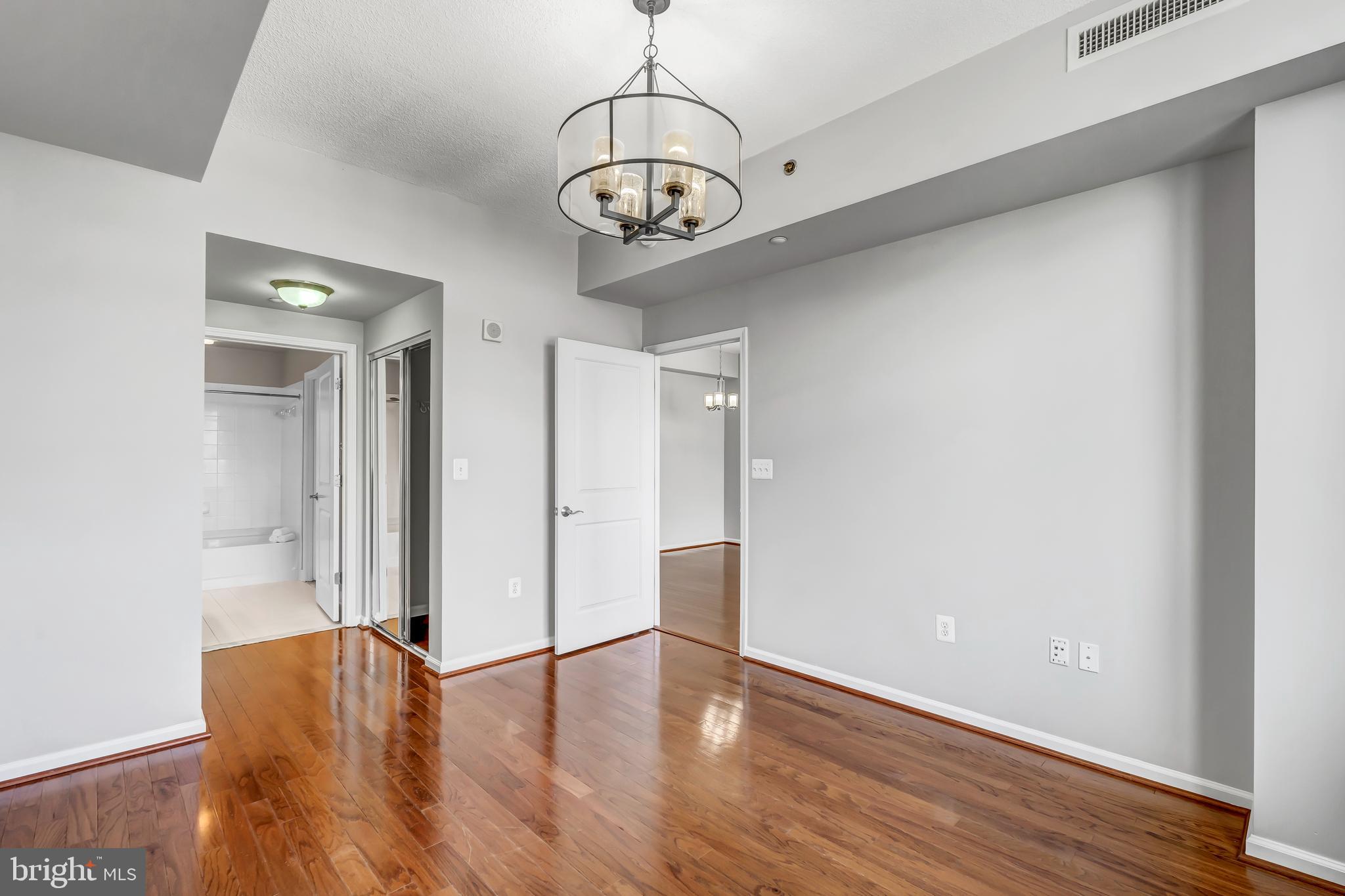 11700 Old Georgetown Road, Unit 1314 North Bethesda, MD 20852 - Photo 15 of 29 a view of an empty room with wooden floor