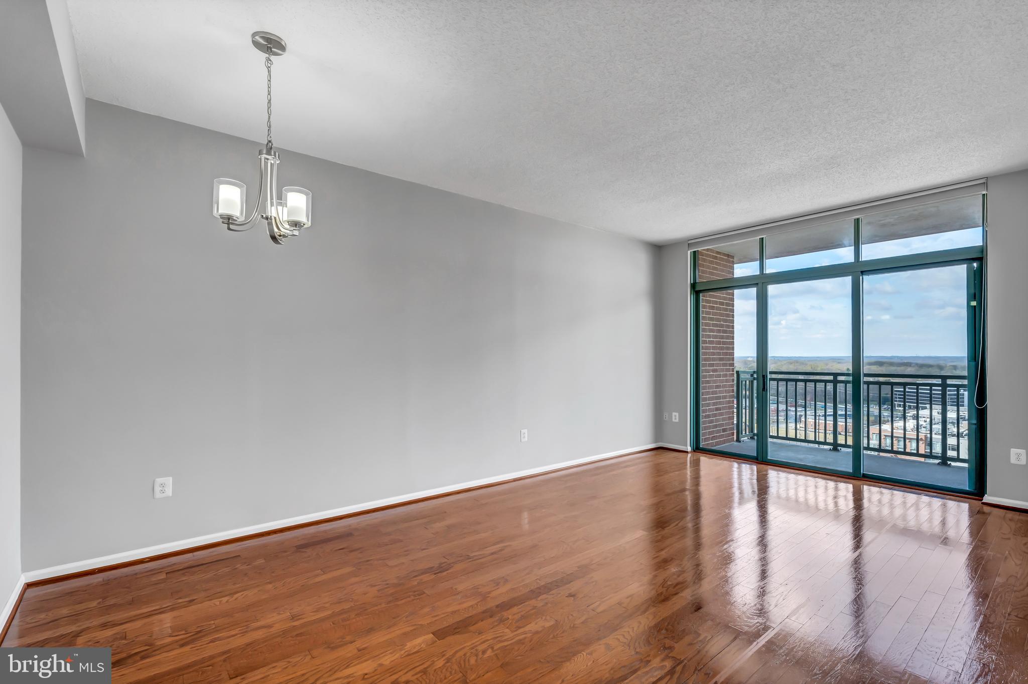 11700 Old Georgetown Road, Unit 1314 North Bethesda, MD 20852 - Photo 20 of 29 a view of a room with wooden floor and large windows
