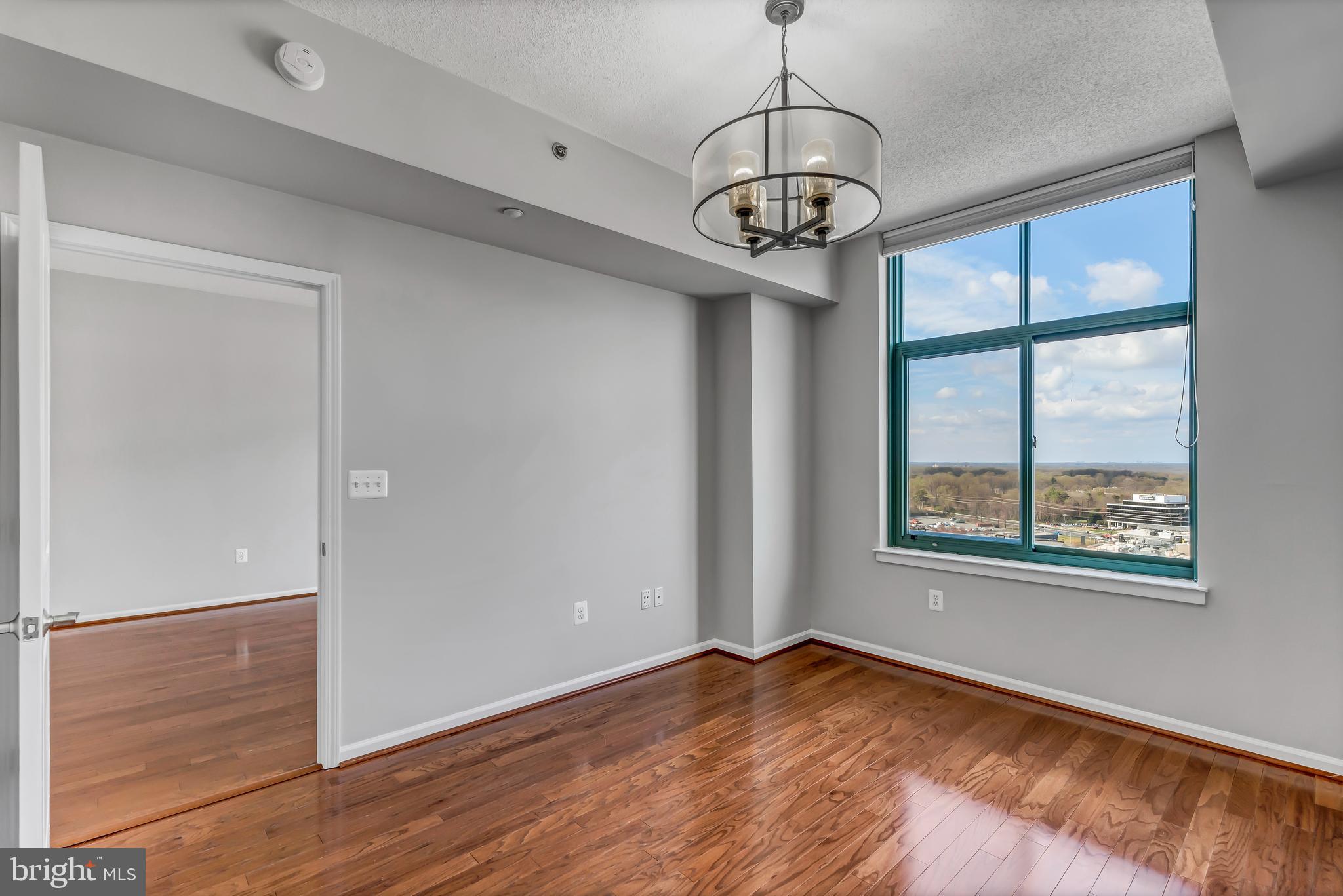 11700 Old Georgetown Road, Unit 1314 North Bethesda, MD 20852 - Photo 22 of 29 a view of a room with wooden floor and windows