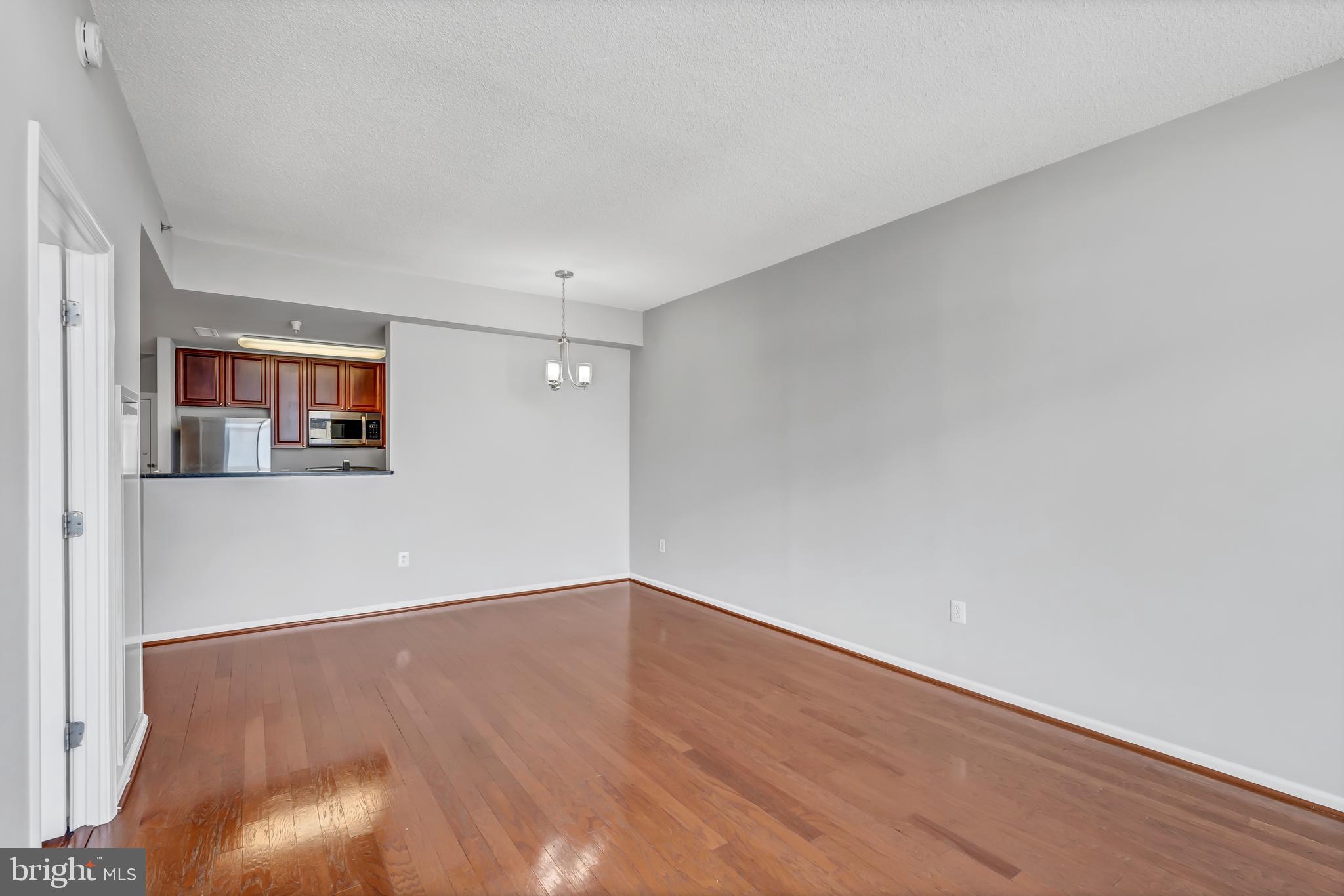 11700 Old Georgetown Road, Unit 1314 North Bethesda, MD 20852 - Photo 23 of 29 a view of an empty room with wooden floor and a window