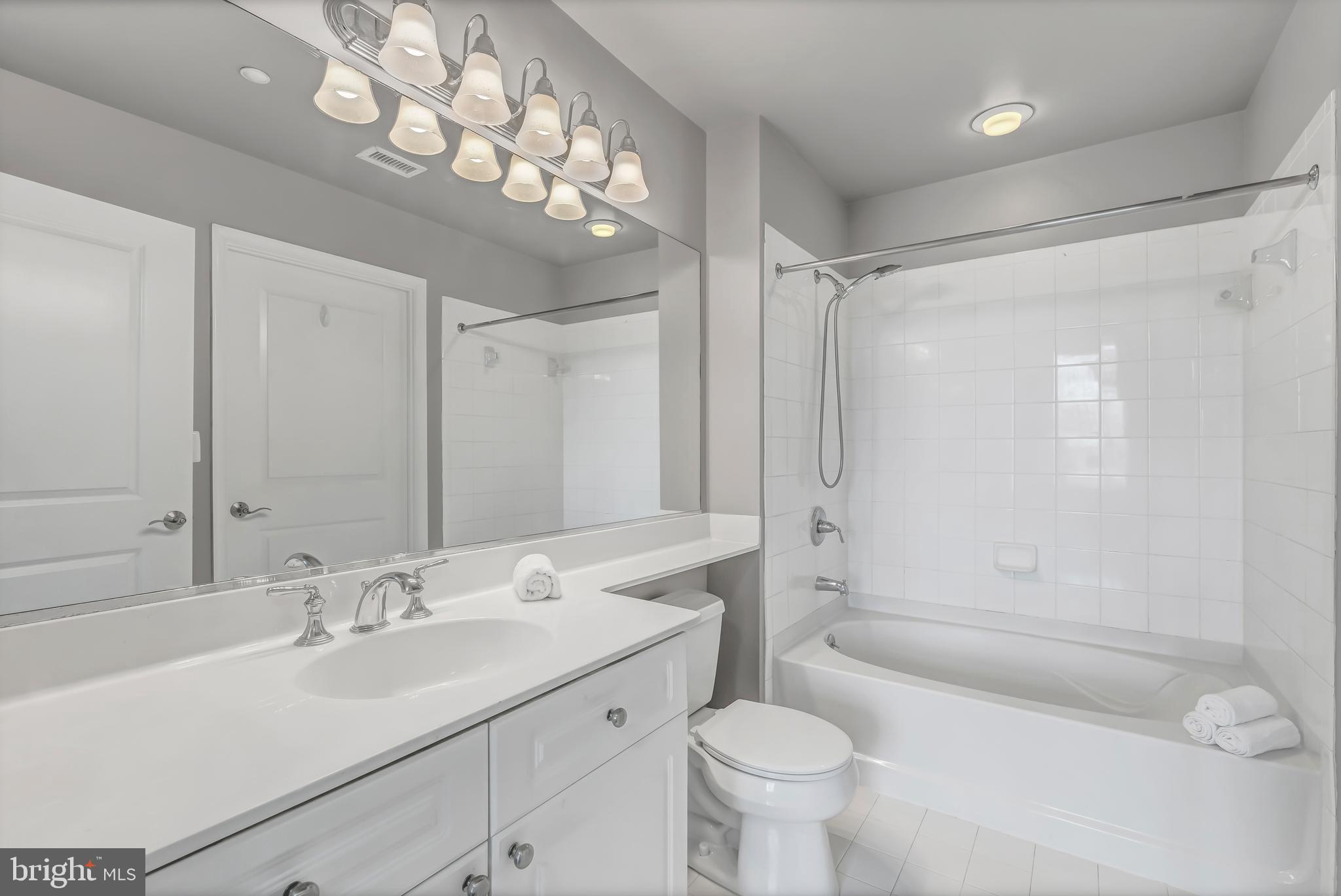 11700 Old Georgetown Road, Unit 1314 North Bethesda, MD 20852 - Photo 25 of 29 a bathroom with a sink a toilet and shower