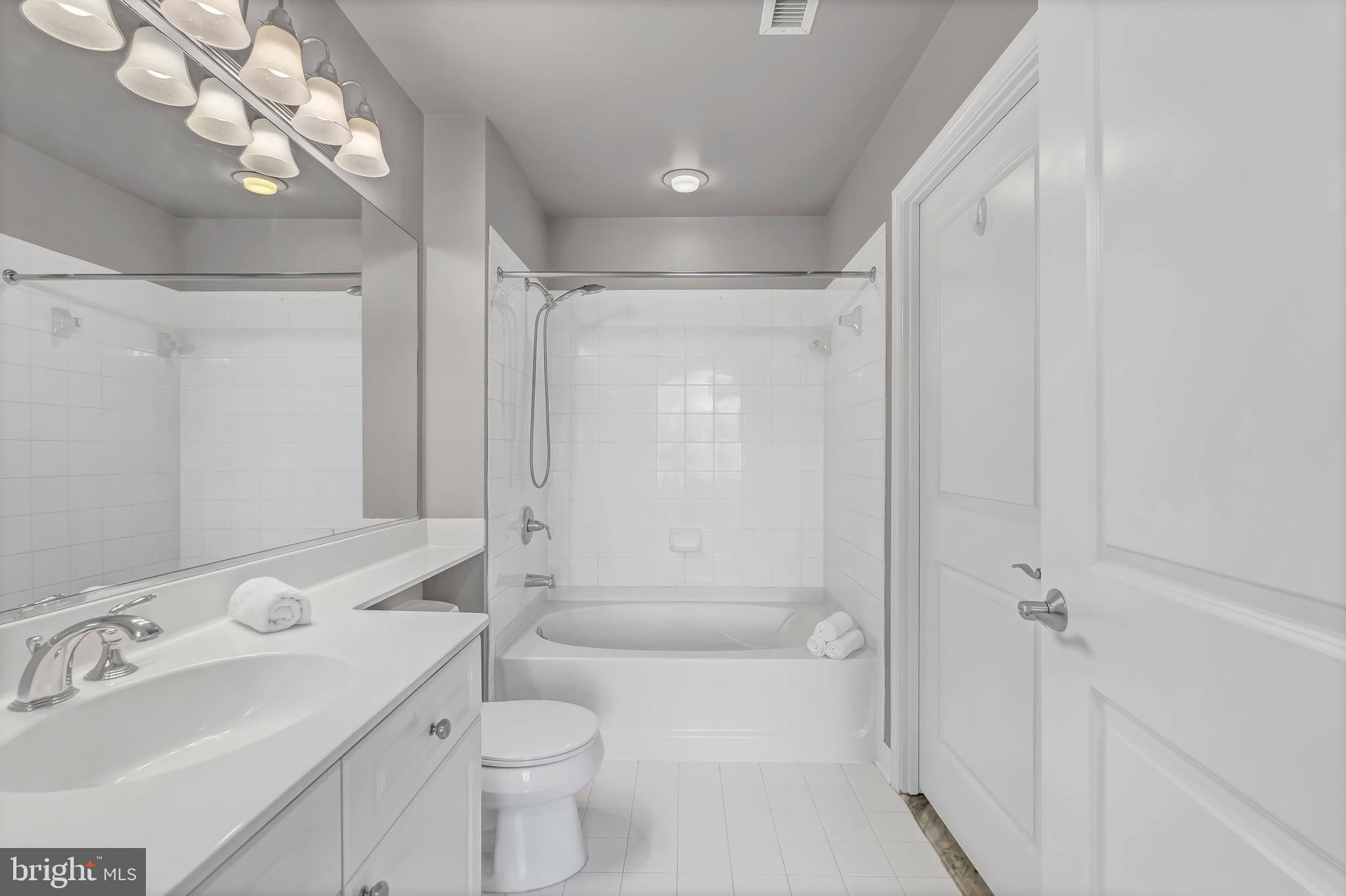 11700 Old Georgetown Road, Unit 1314 North Bethesda, MD 20852 - Photo 26 of 29 a bathroom with a sink toilet mirror and shower