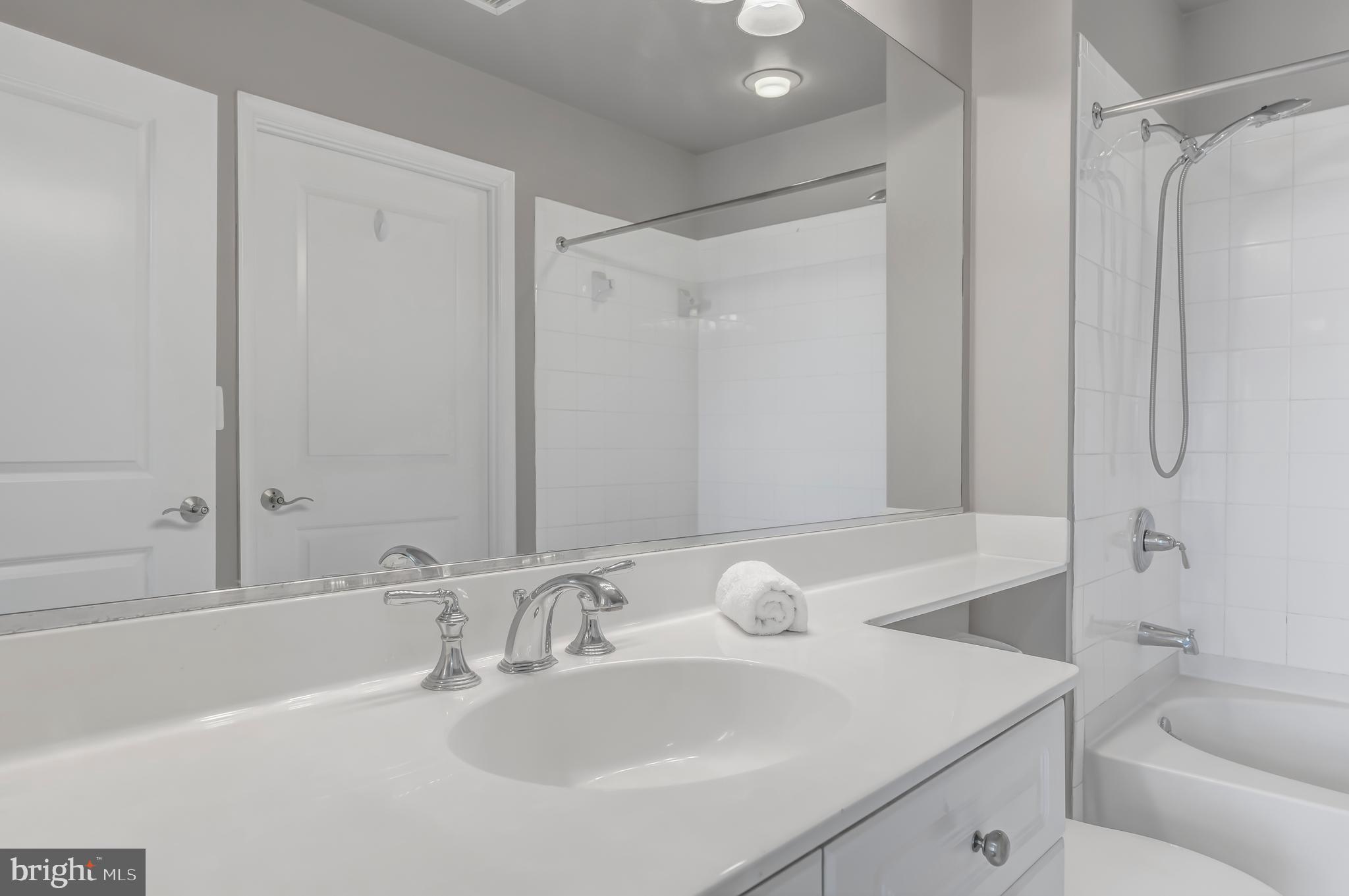 11700 Old Georgetown Road, Unit 1314 North Bethesda, MD 20852 - Photo 27 of 29 a bathroom with a sink toilet and shower