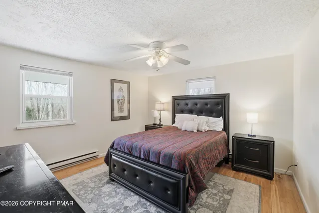 a bedroom with a bed and a night stand