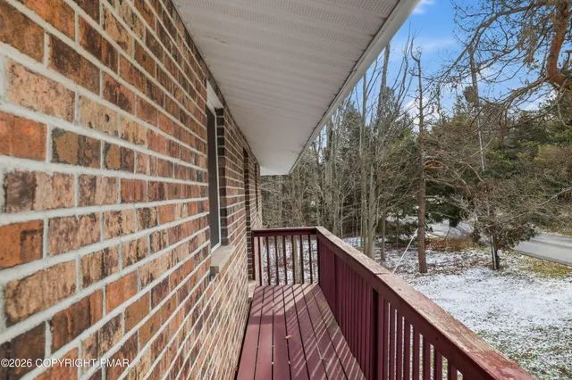 a view of a balcony with wooden floor