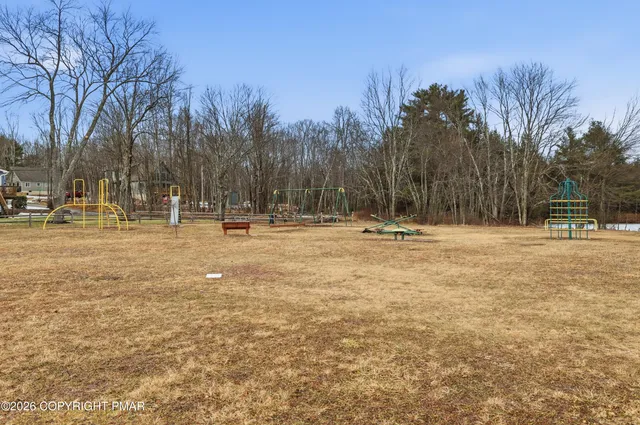 a view of outdoor space with swimming pool and seating
