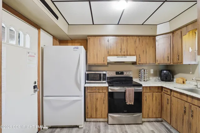 a white refrigerator freezer sitting inside of a kitchen