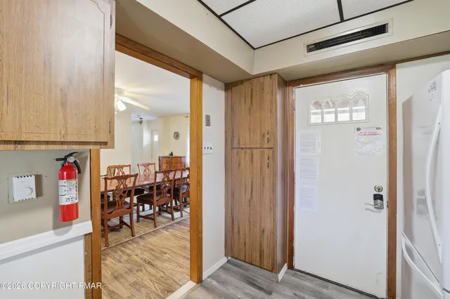 a view of a hallway with dining area and glass door