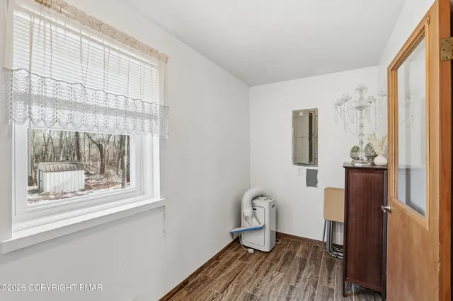 a view of a room with wooden floor and furniture
