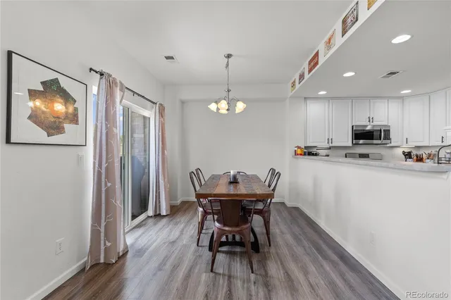 a view of a dining room with furniture and wooden floor