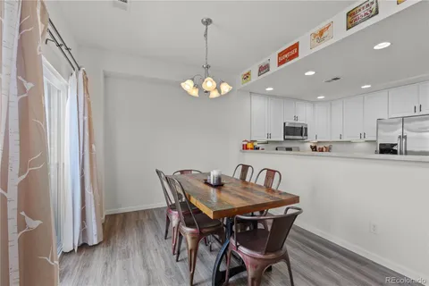 a view of a dining room with furniture wooden floor and a chandelier
