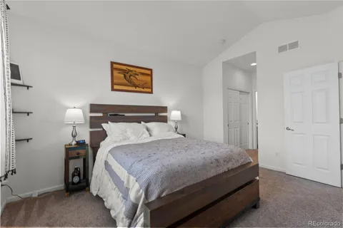 a bedroom with a bed and a night stand