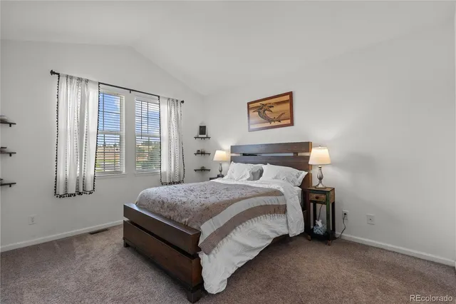 a bed sitting in a bedroom next to a window