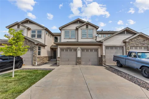 a front view of a house with a garden and plants
