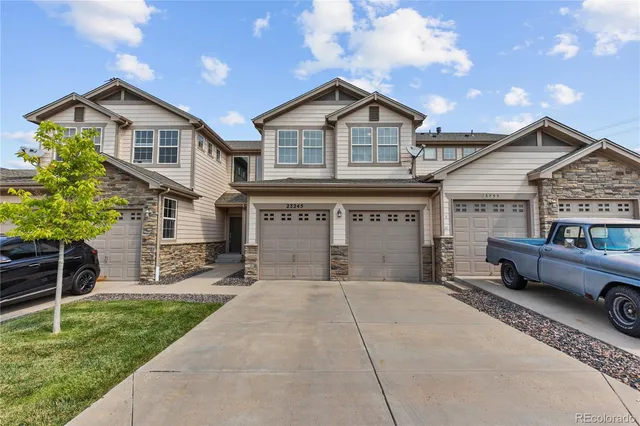 a front view of a house with a garden and plants