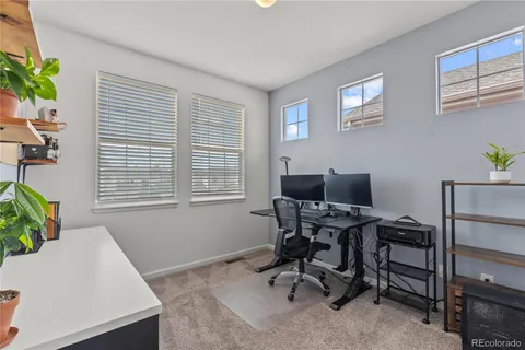 a view of a workspace with a window and piano