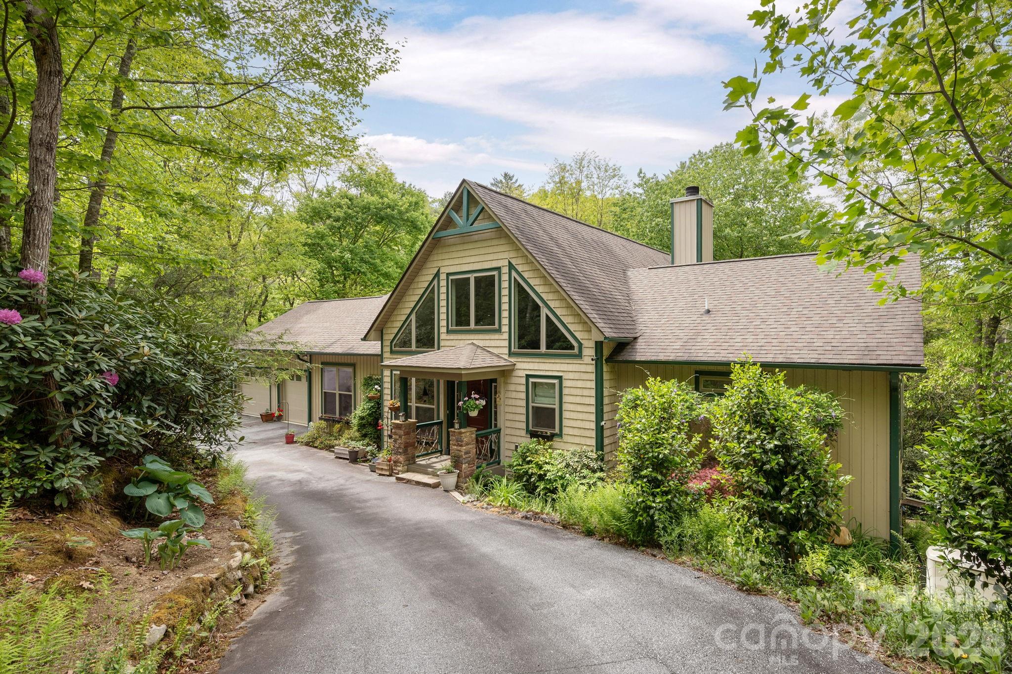 149 Hiwassee Road Lake Toxaway, NC 28747 - Photo 3 of 48 a front view of a house with a yard and fountain